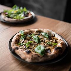 Two pizzas with vegetable toppings