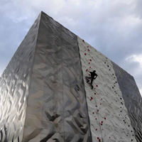 A man is climbing on the outdoor wall of the Vertikale climbing gym